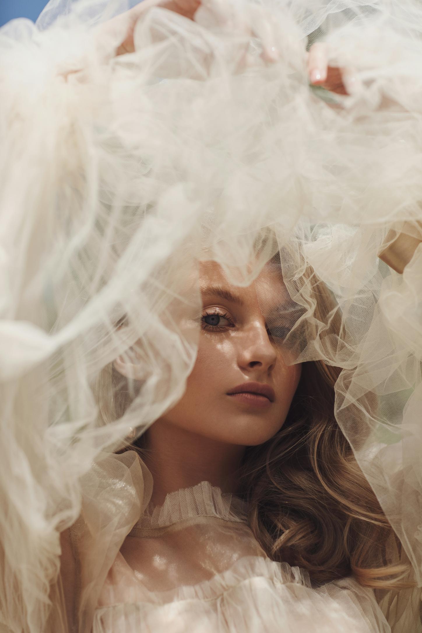 Bridal portrait framed by a billowing tulle veil